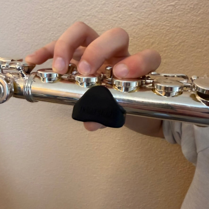 Student using flute training aid for correct hand position and balance